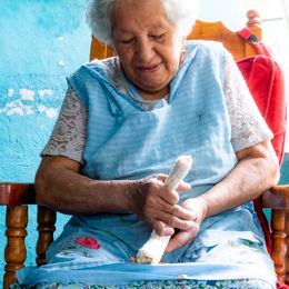 An older woman sitting on her porch